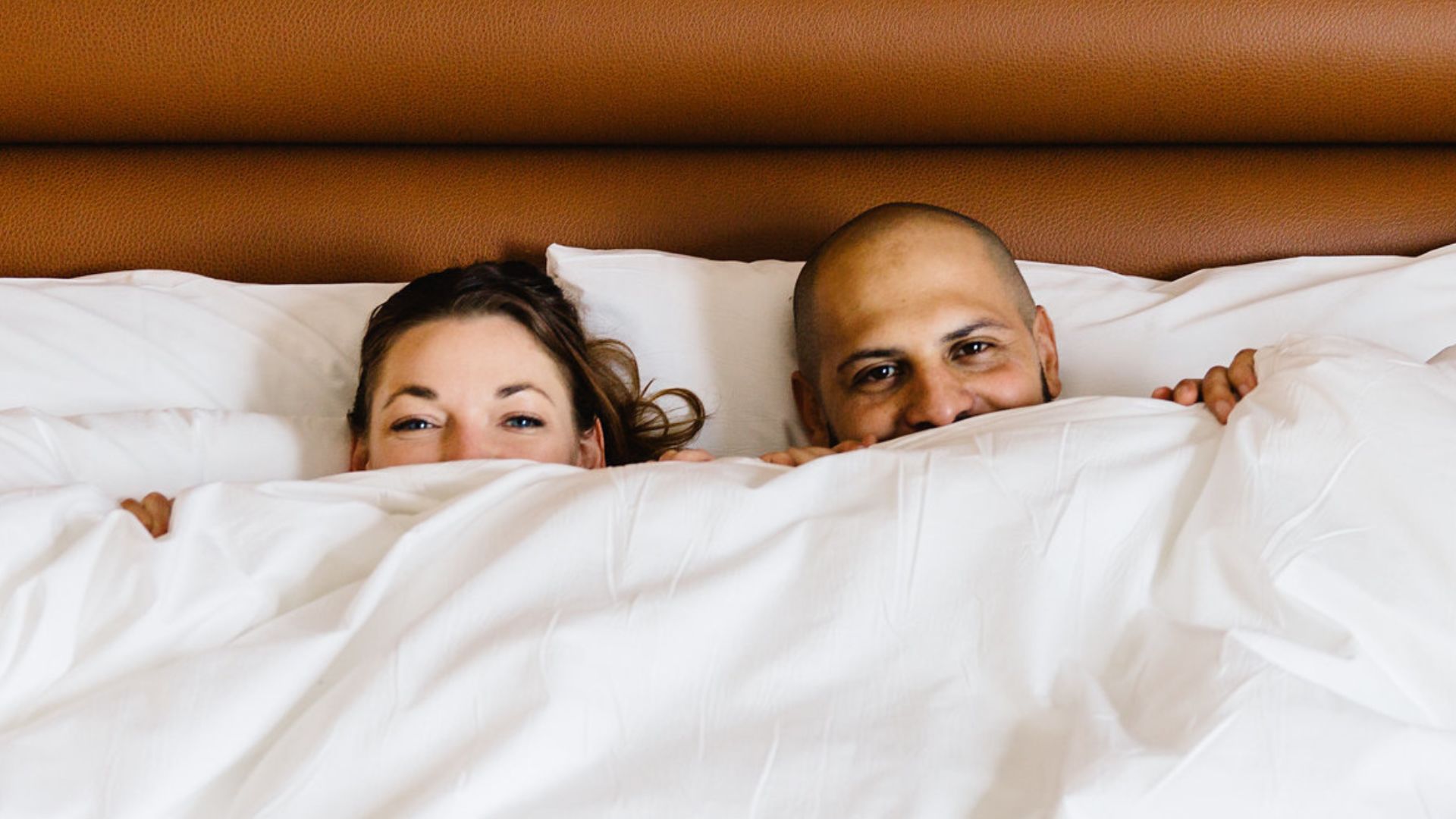 A Man And Woman Lying In Bed