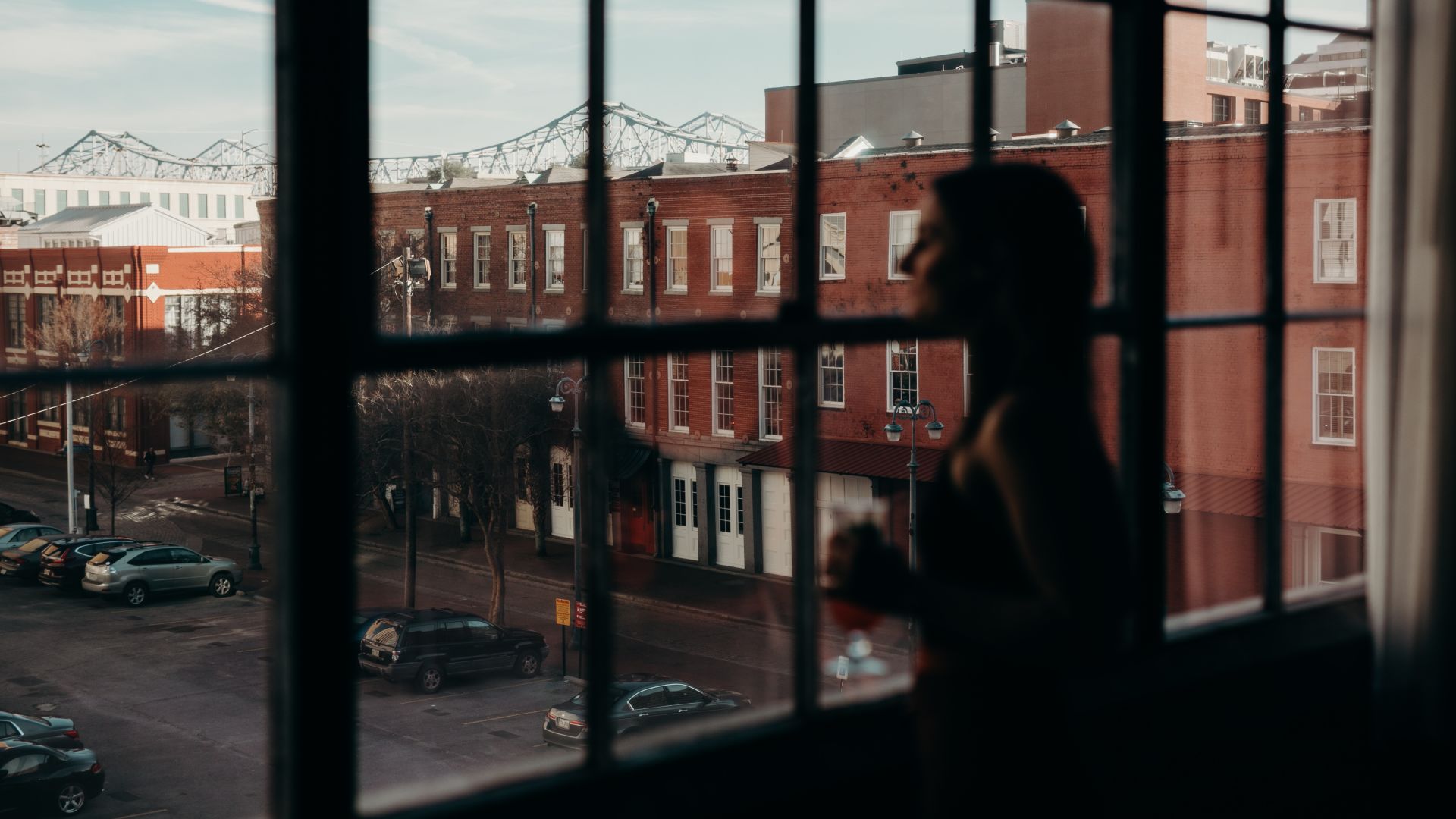 A Person Standing In Front Of A Window
