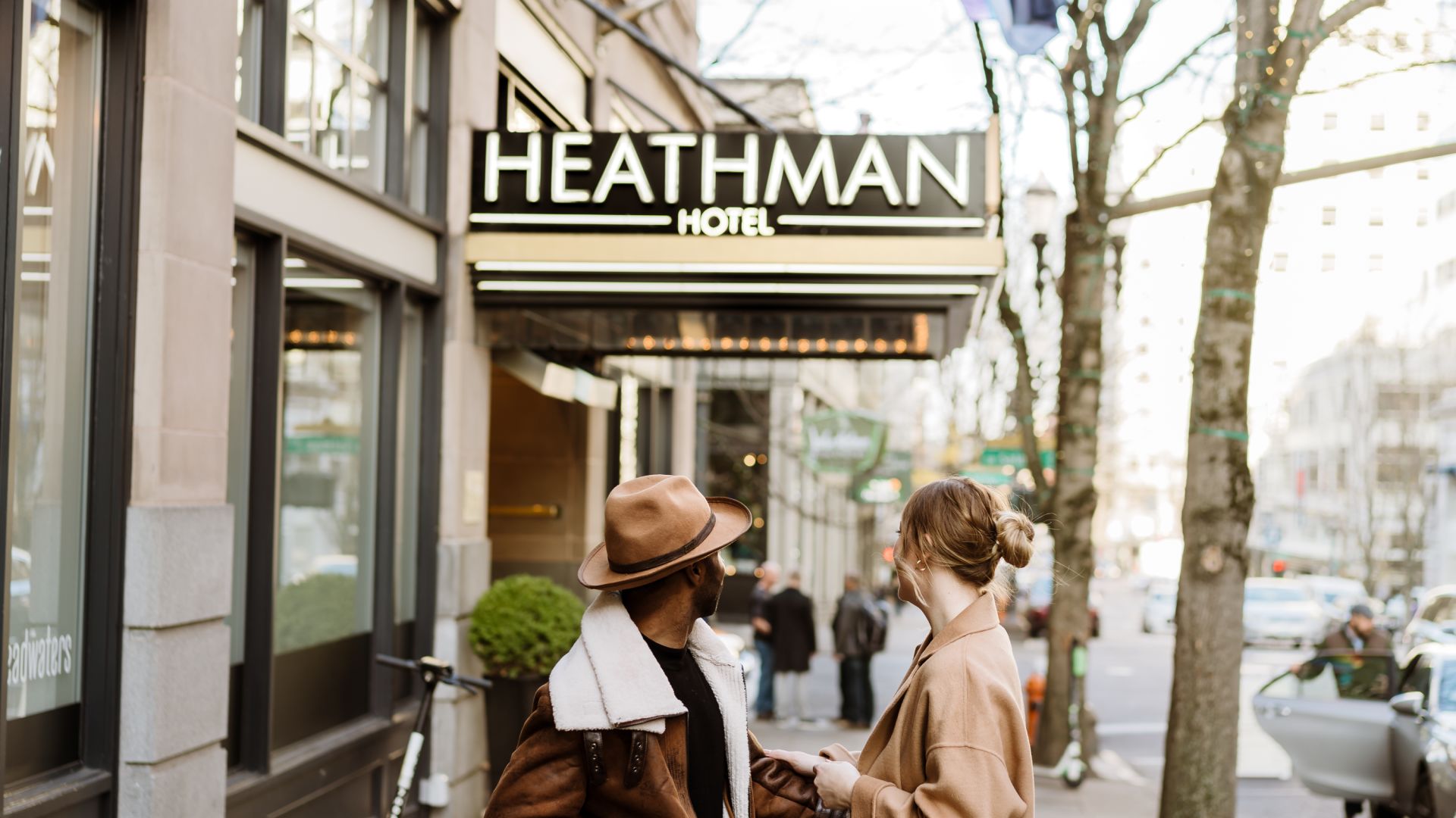 A Man And A Woman Walking Down A Street