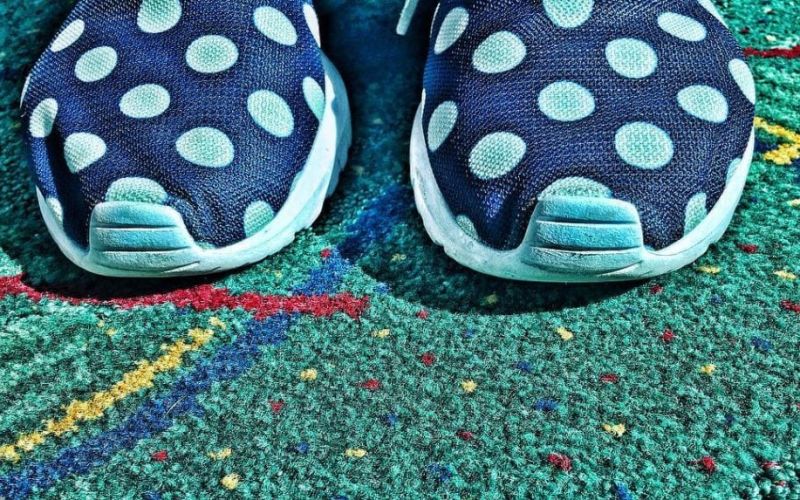 PDX airport carpet closeup with sneakers.