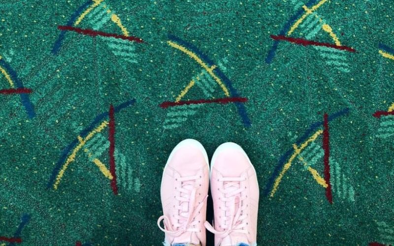 Shoes on the PDX airport carpet from above. 